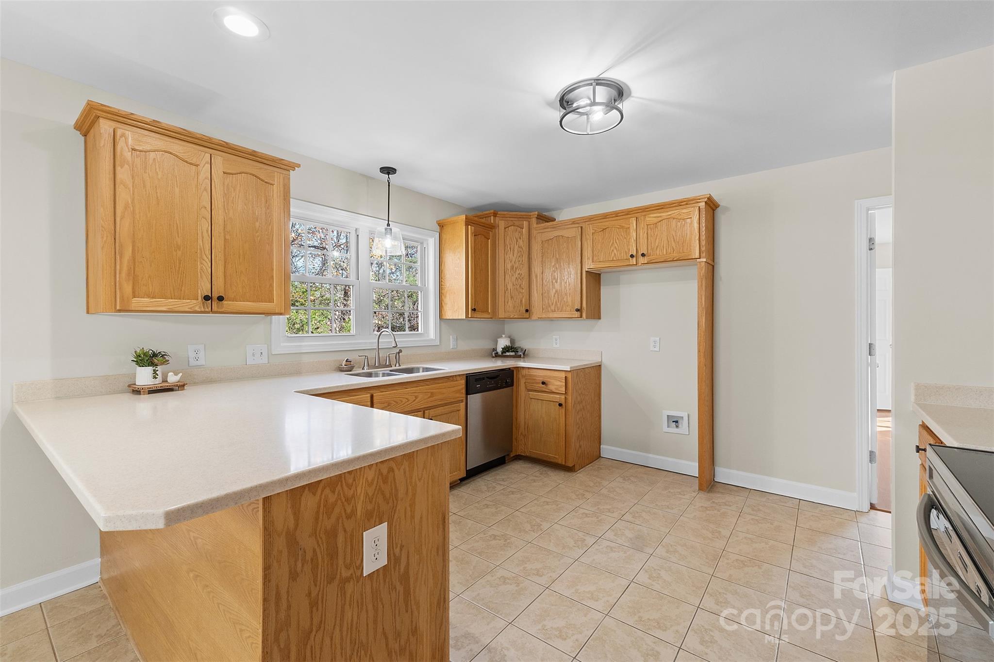 490 Rutledge Drive Catawba, SC 29704 - Photo 9 of 33 a kitchen with stainless steel appliances a sink a stove a refrigerator cabinets and a window