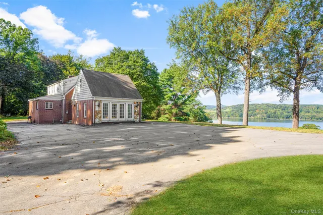 a view of a house with backyard and a trees