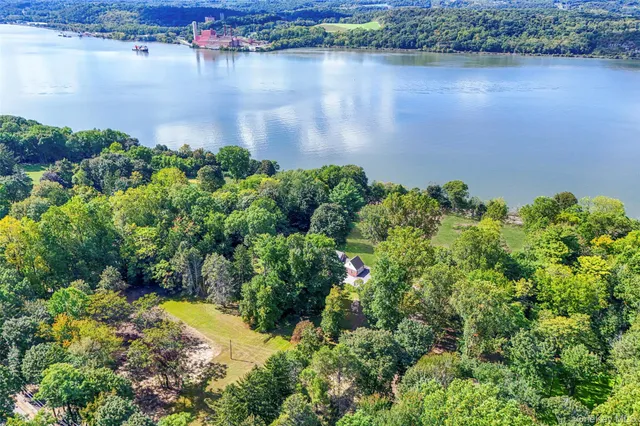an aerial view of a houses with a lake view