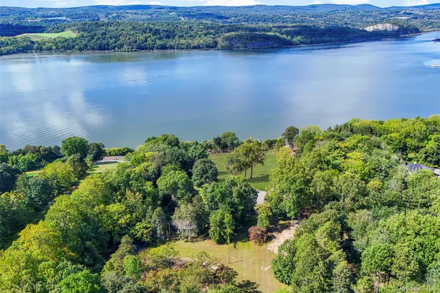 an aerial view of a houses with a lake view