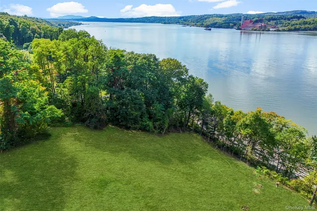 a view of a lake with a yard and mountain view