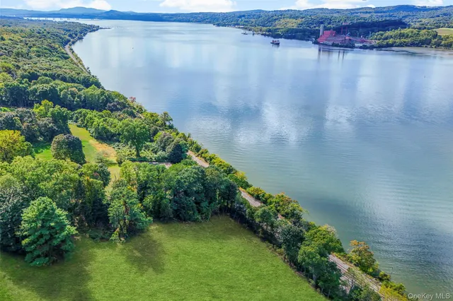 a view of a lake with a yard and mountain view