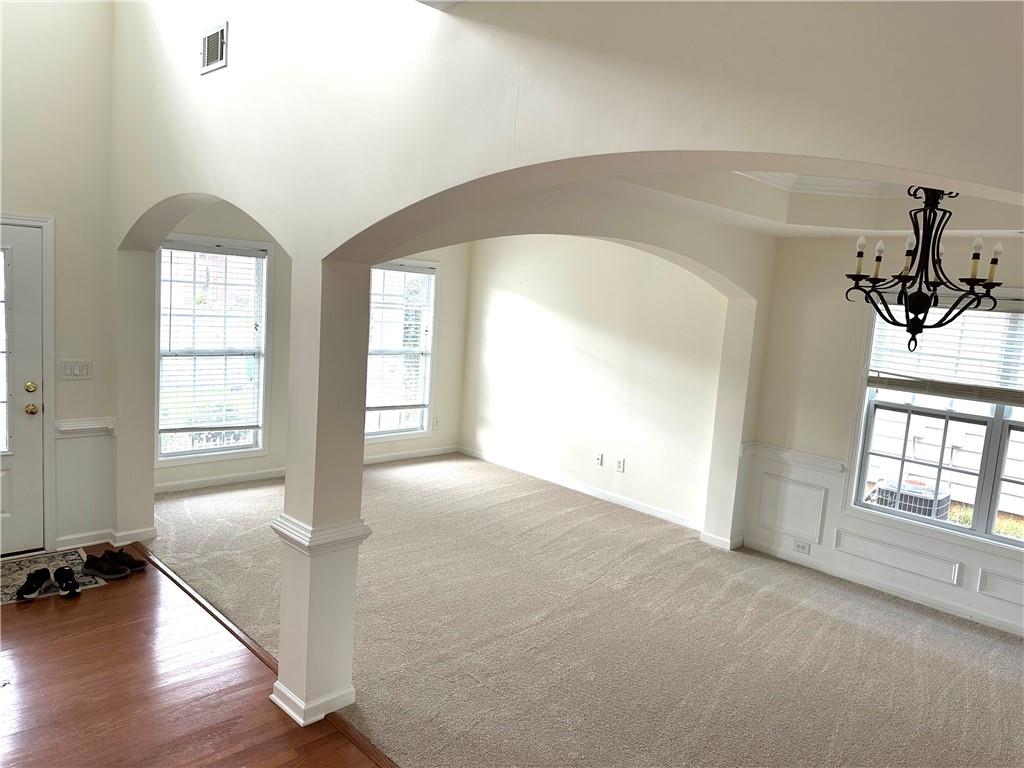 5876 Rue Villa Lane Tucker, GA 30084 - Photo 4 of 17 an empty room with wooden floor and windows