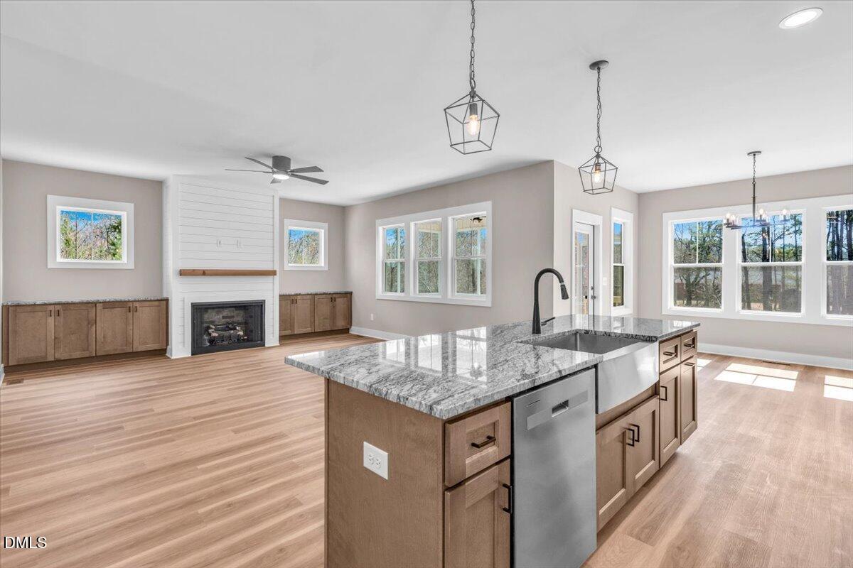 12615 Mallard Rock Drive Zebulon, NC 27597 - Photo 11 of 89 a kitchen with granite countertop a stove and a wooden floor