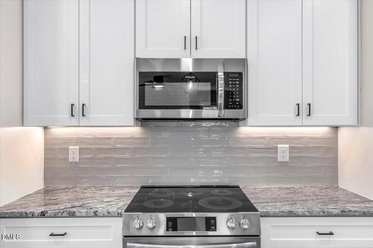 12615 Mallard Rock Drive Zebulon, NC 27597 - Photo 21 of 89 a stove top oven sitting inside of a kitchen