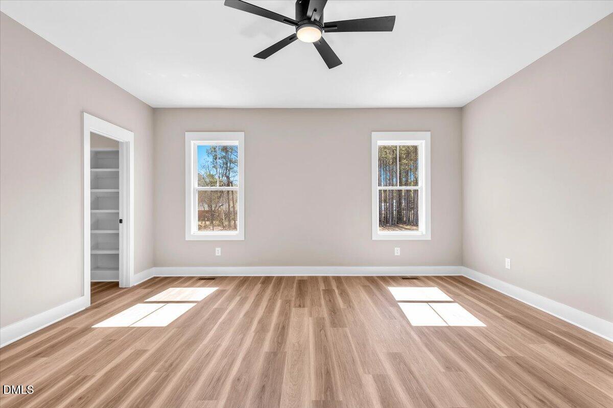 12615 Mallard Rock Drive Zebulon, NC 27597 - Photo 33 of 89 a view of empty room with wooden floor and window
