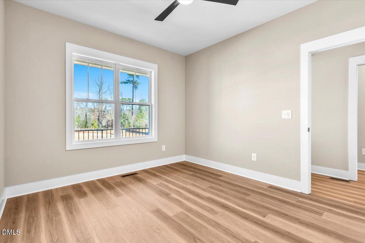 12615 Mallard Rock Drive Zebulon, NC 27597 - Photo 47 of 89 a view of an empty room with wooden floor and a window