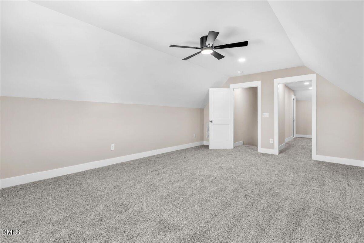 12615 Mallard Rock Drive Zebulon, NC 27597 - Photo 66 of 89 a view of a room with closet and ceiling fan