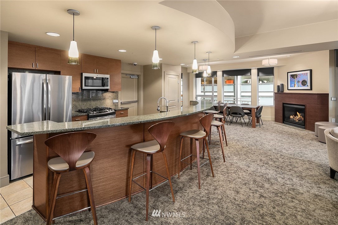 819 Virginia Street, Unit 1006 Seattle, WA 98101 - Photo 16 of 20 a large kitchen with a table and chairs