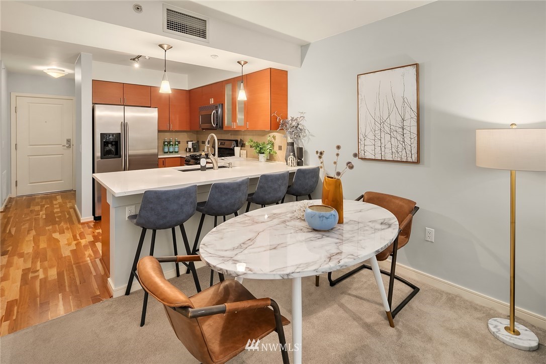 819 Virginia Street, Unit 1006 Seattle, WA 98101 - Photo 4 of 20 a view of kitchen with dining area and chandelier
