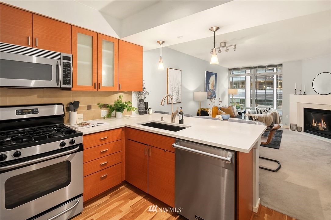 819 Virginia Street, Unit 1006 Seattle, WA 98101 - Photo 5 of 20 a kitchen with a sink stove and microwave