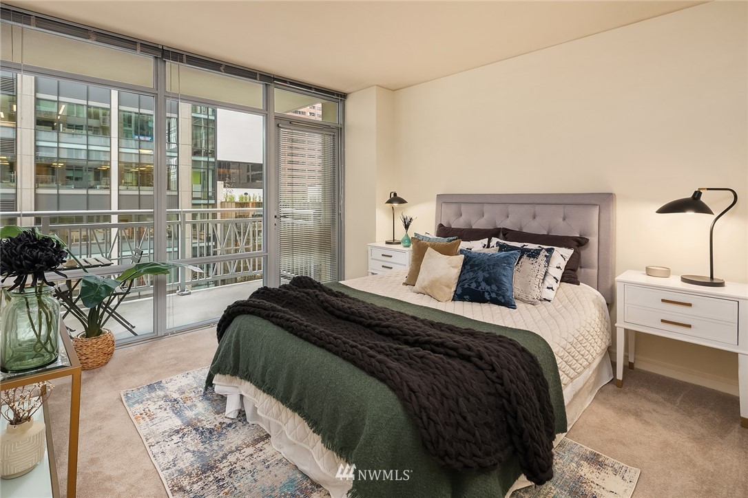 819 Virginia Street, Unit 1006 Seattle, WA 98101 - Photo 7 of 20 a bedroom with a large bed and a large window
