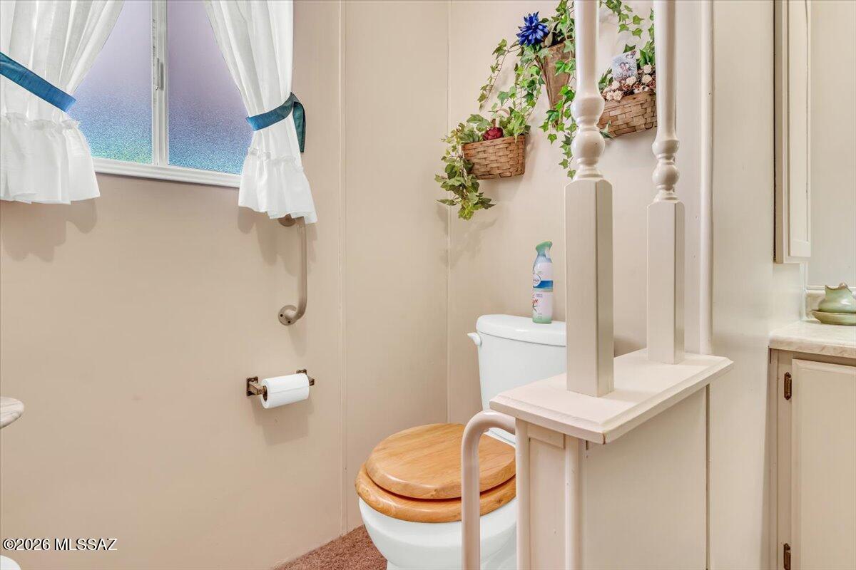 5840 West Flying W Street Tucson, AZ 85713 - Photo 19 of 38 a bathroom with a toilet sink and mirror