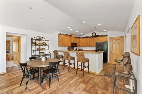 a large kitchen with stainless steel appliances granite countertop a stove top oven a sink dishwasher and wooden cabinets