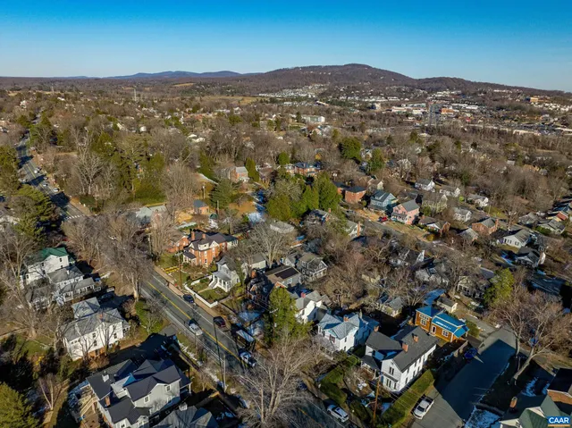 an aerial view of residential houses with city view