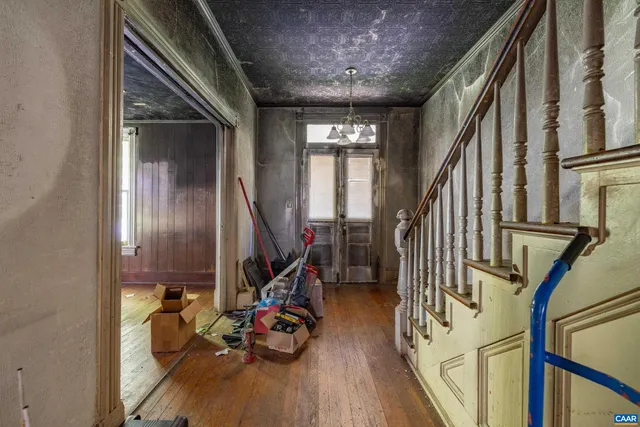 a view of a livingroom with furniture and stairs