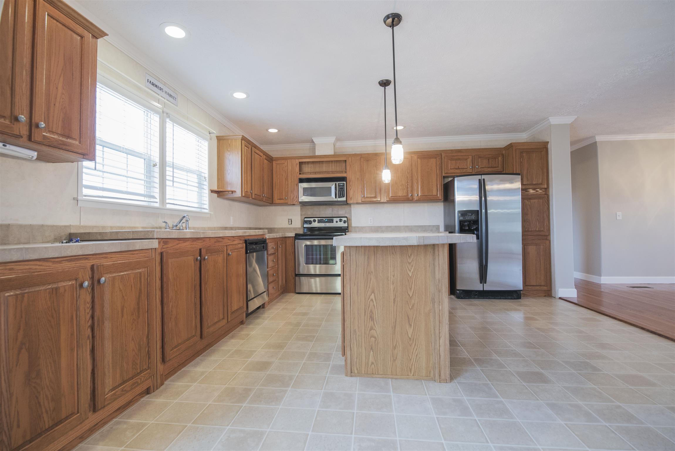 1227 Linwood Road Watertown, TN 37184 - Photo 21 of 29 a kitchen with stainless steel appliances granite countertop a stove a sink a refrigerator and island
