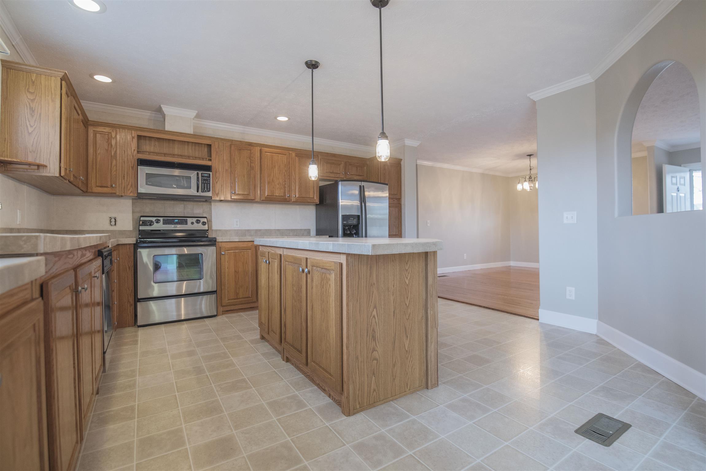 1227 Linwood Road Watertown, TN 37184 - Photo 22 of 29 a kitchen with stainless steel appliances granite countertop a sink a stove and a refrigerator