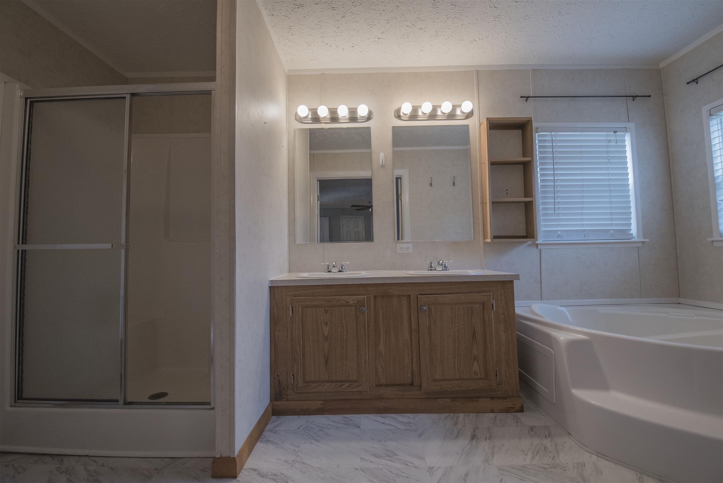 1227 Linwood Road Watertown, TN 37184 - Photo 24 of 29 a bathroom with a double vanity sink a mirror and a bathtub