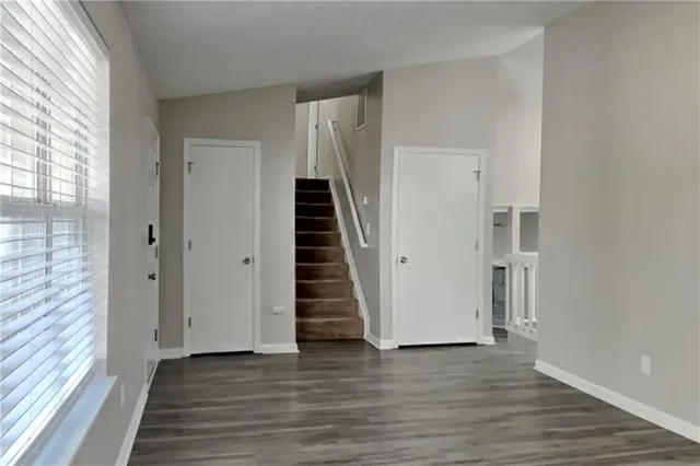 a view of a hallway with wooden floor and entryway