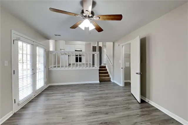 a view of a kitchen with wooden floor and a ceiling fan