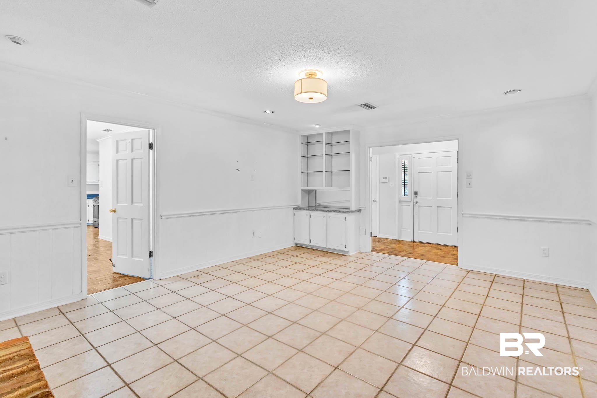 309 West Brandy Run Road Mobile, AL 36608 - Photo 15 of 100 Unfurnished room featuring light tile patterned floors, a textured ceiling, and wainscoting