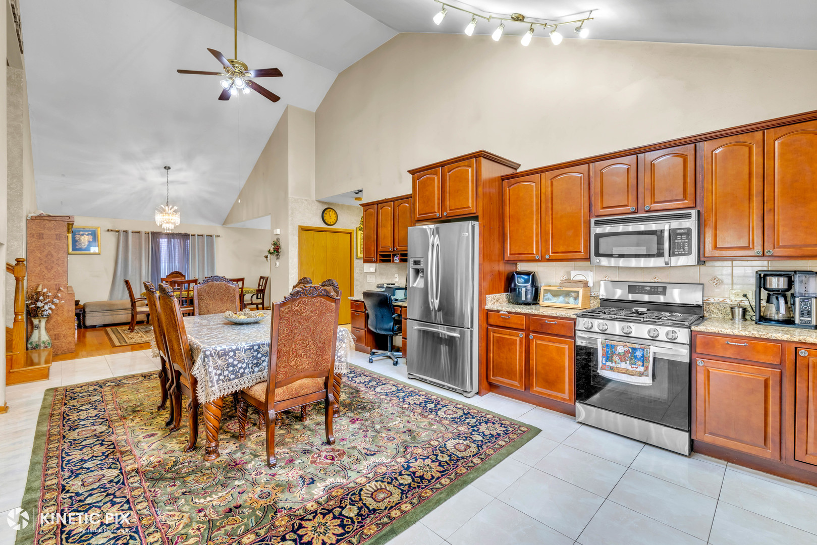 8619 Linder Avenue Burbank, IL 60459 - Photo 12 of 40 a dining room with stainless steel appliances kitchen island granite countertop a table chairs and a refrigerator