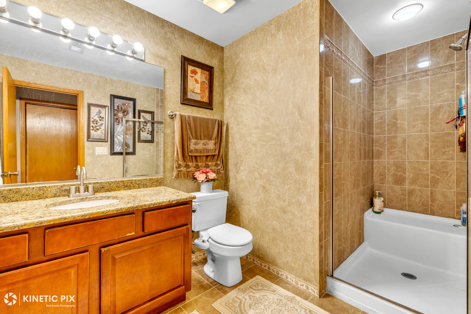 8619 Linder Avenue Burbank, IL 60459 - Photo 27 of 40 a bathroom with a granite countertop sink toilet a large mirror a shower and a bathtub
