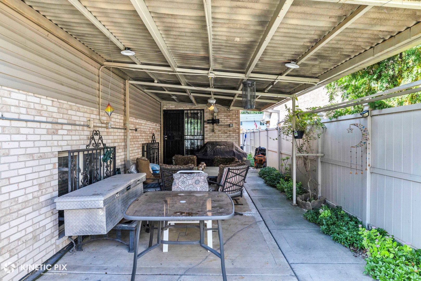 8619 Linder Avenue Burbank, IL 60459 - Photo 33 of 40 a view of a patio with table and chairs with wooden fence