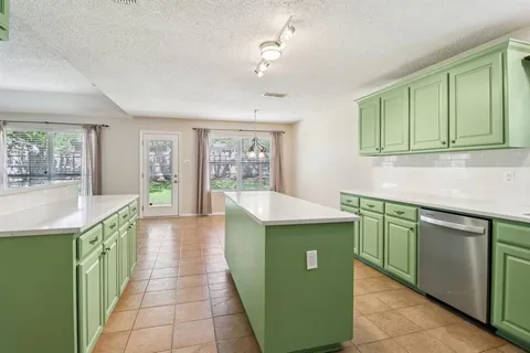 a kitchen with a sink cabinets and a microwave