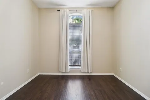 an empty room with wooden floor