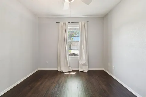 an empty room with wooden floor