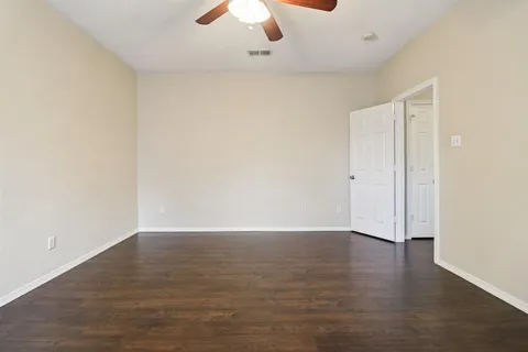 a spacious bathroom with a tub sink and a mirror