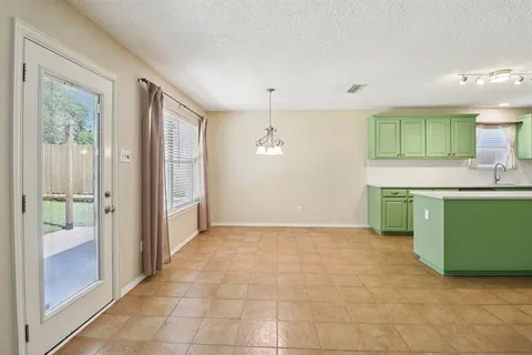 a view of a kitchen with a sink and a window
