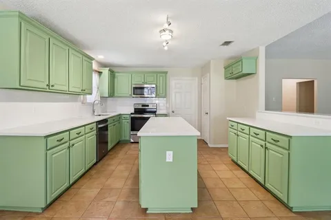a kitchen with lots of counter top space sink and stove