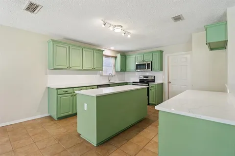 a kitchen with a sink and a refrigerator