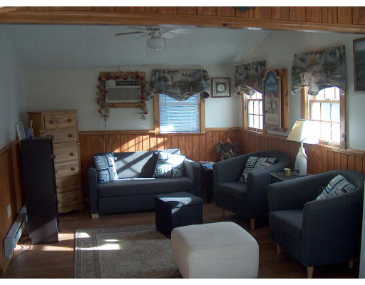 4 A Thompson Road Bourne, MA 02532 - Photo 1 of 9 a living room with furniture and a flat screen tv