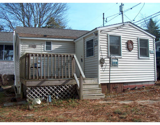 4 A Thompson Road Bourne, MA 02532 - Photo 2 of 9 a front view of a house with a yard