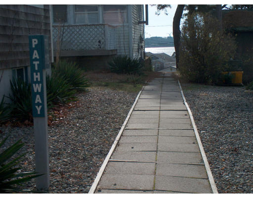 4 A Thompson Road Bourne, MA 02532 - Photo 8 of 9 a view of a pathway both side of the house