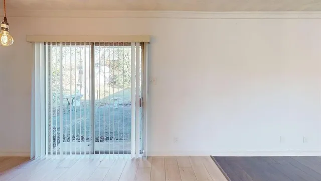 a view of a room with wooden floor and windows
