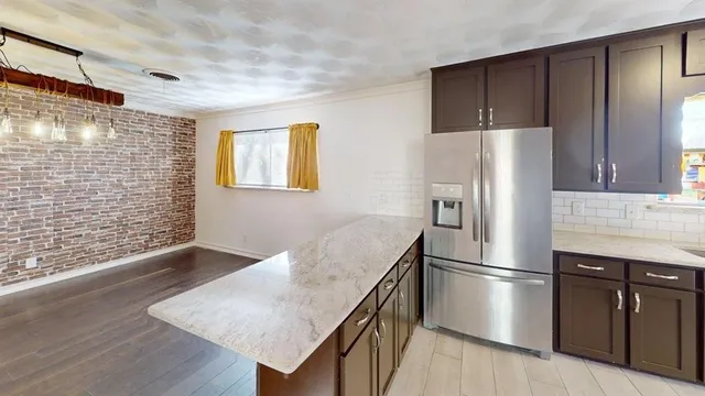 a kitchen with stainless steel appliances a refrigerator and a stove
