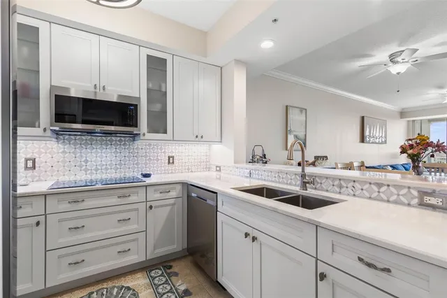 a kitchen with a sink stove and cabinets