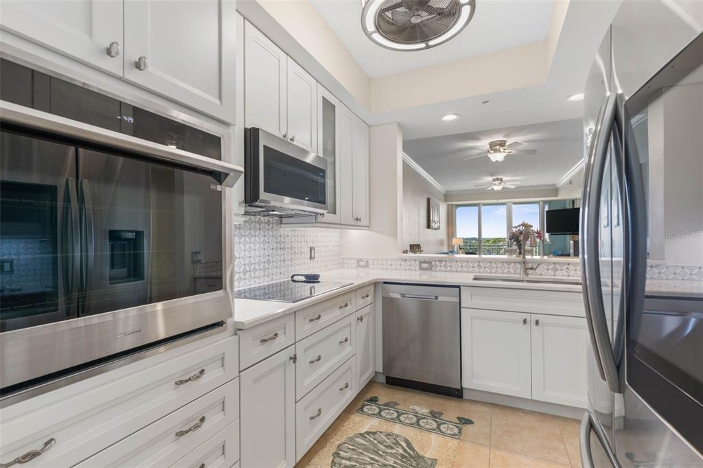 102 Yacht Harbor Drive, Unit 567 Palm Coast, FL 32137 - Photo 13 of 59 a large kitchen with stainless steel appliances granite countertop a sink and cabinets