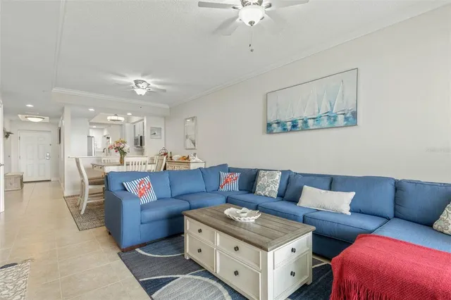 a kitchen with granite countertop a sink a stove a refrigerator a dining table and chairs with wooden floor