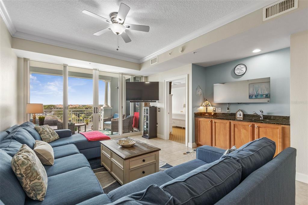 102 Yacht Harbor Drive, Unit 567 Palm Coast, FL 32137 - Photo 22 of 59 a living room with furniture kitchen view and a large window