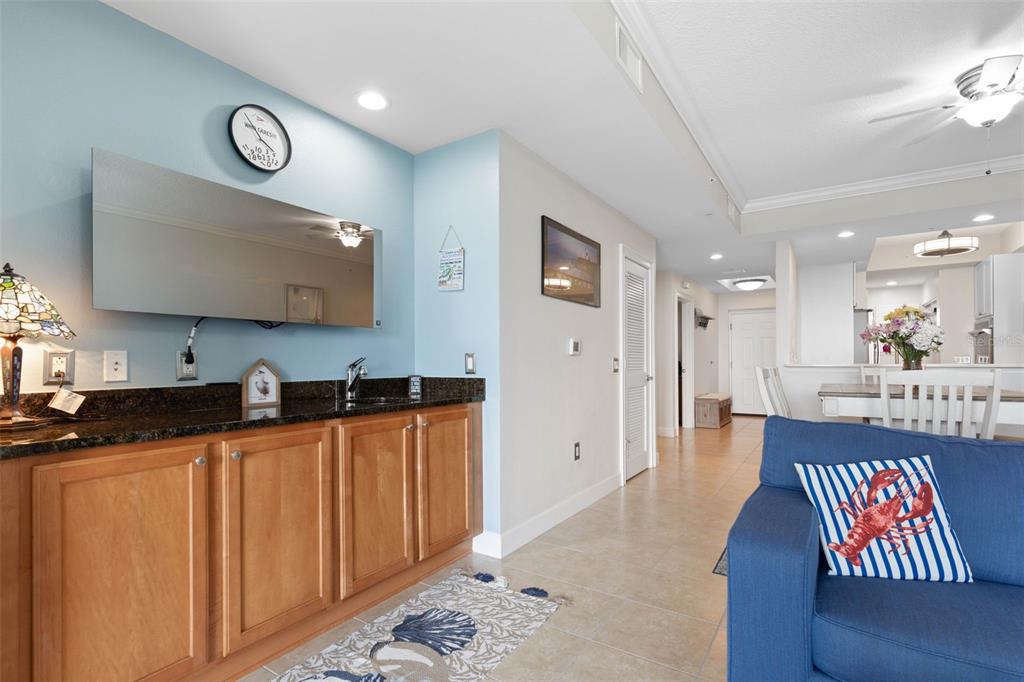 102 Yacht Harbor Drive, Unit 567 Palm Coast, FL 32137 - Photo 24 of 59 a kitchen with granite countertop a sink a stove a refrigerator a dining table and chairs with wooden floor