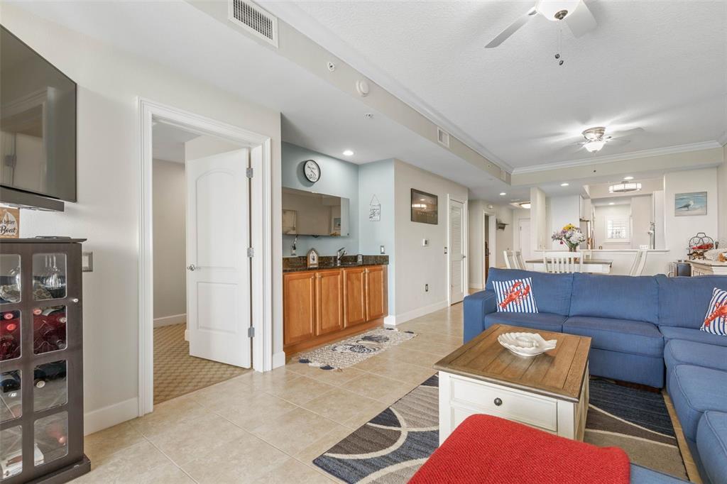 102 Yacht Harbor Drive, Unit 567 Palm Coast, FL 32137 - Photo 25 of 59 a living room with furniture a flat screen tv and kitchen view