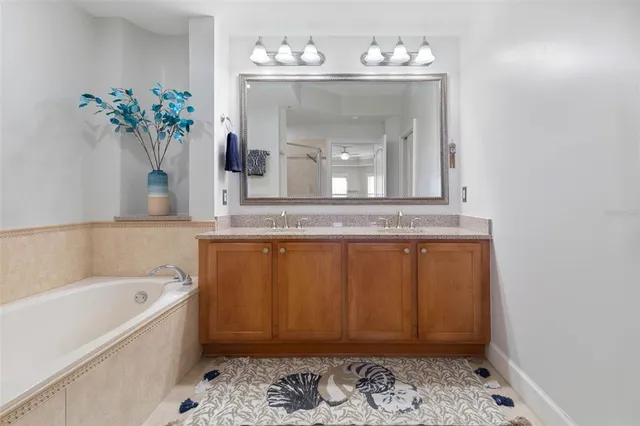 a bathroom with a granite countertop sink toilet a mirror and shower