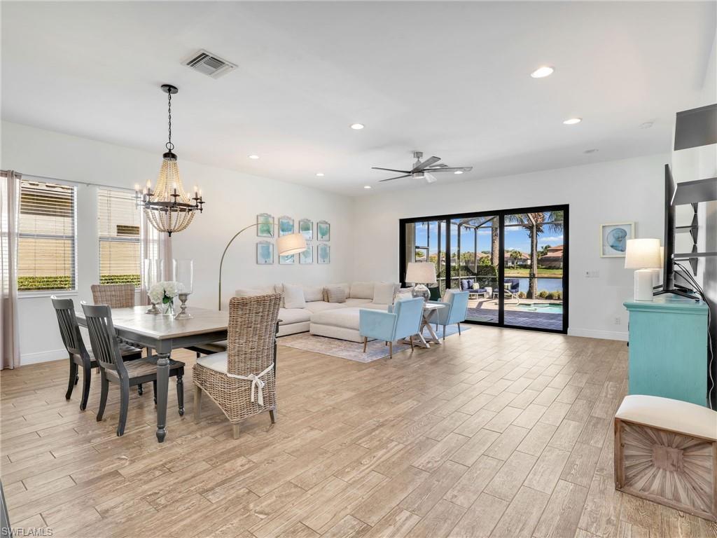 4743 Abaca Circle Naples, FL 34119 - Photo 11 of 50 Dining space with ceiling fan, light wood-type flooring, recessed lighting, and a chandelier