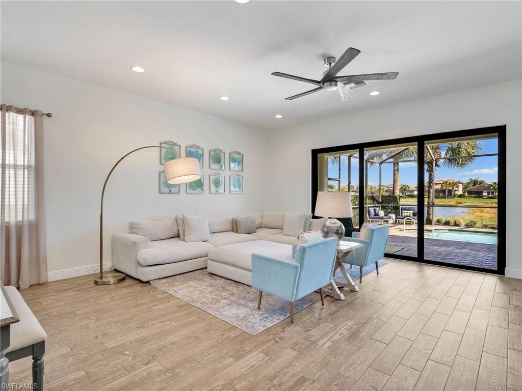 4743 Abaca Circle Naples, FL 34119 - Photo 12 of 50 Living room with light wood-style flooring, ceiling fan, and recessed lighting